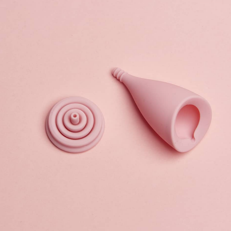 kubeczek-menstruacyjny-lily-cup-intimina-w-rozlozonej-formie-na-jasnorozowym-tle-ekologiczny-produkt-higieniczny-zaprojektowany-dla-komfortu-i-zdrowia